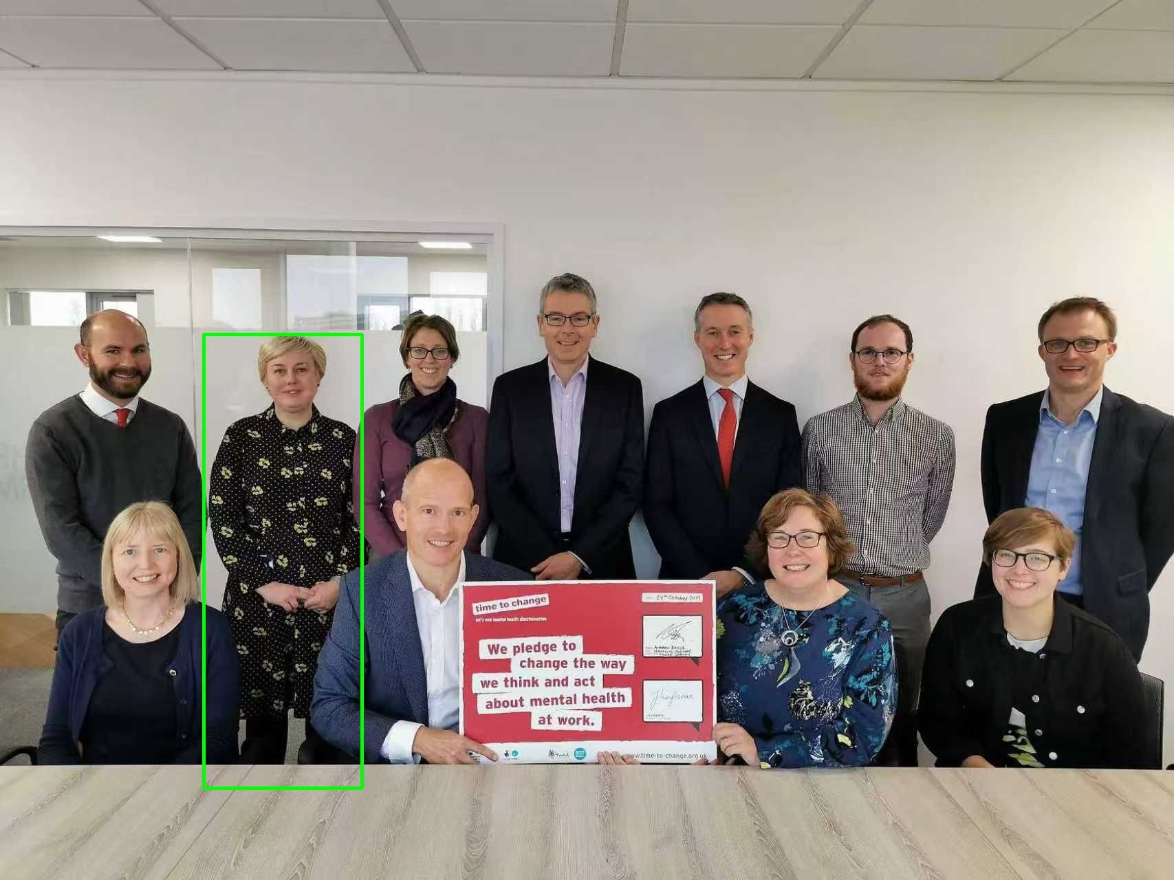 Photo of two dogs running side-by-side in shallow water