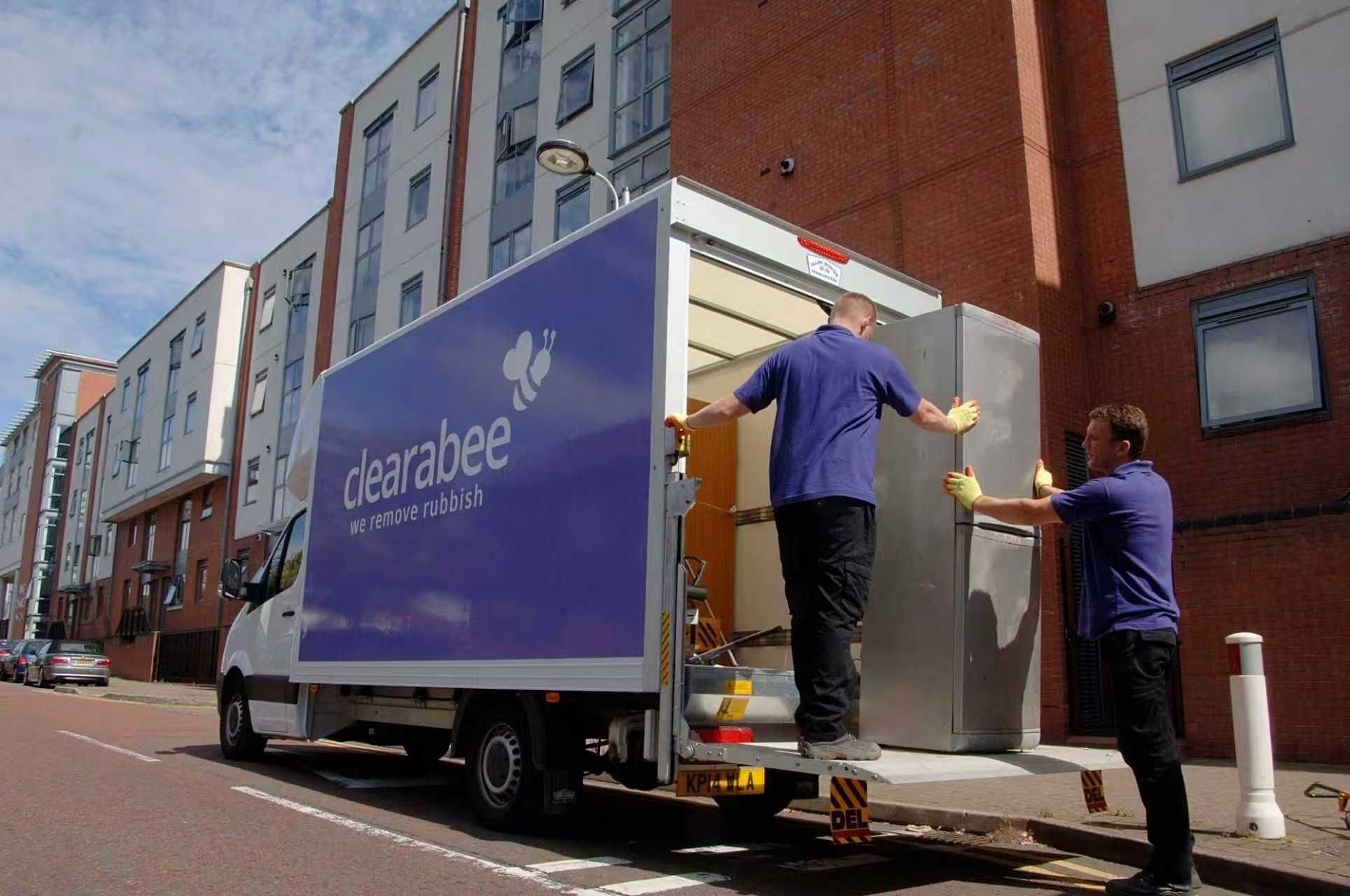 Photo of two dogs running side-by-side in shallow water